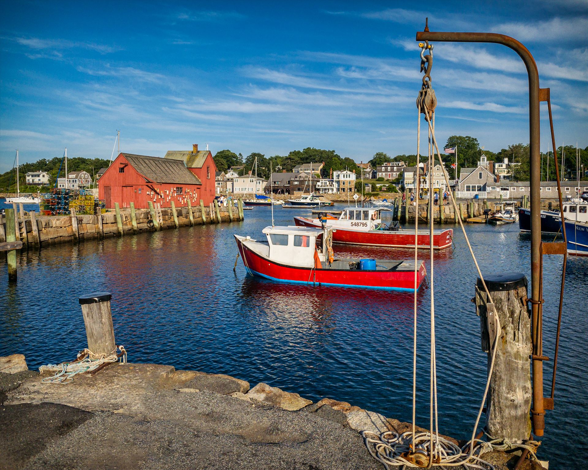 Red fishing boats complement Motif #1 at Rockport Harbor in Rockport, Massachusetts -  by New England Photography