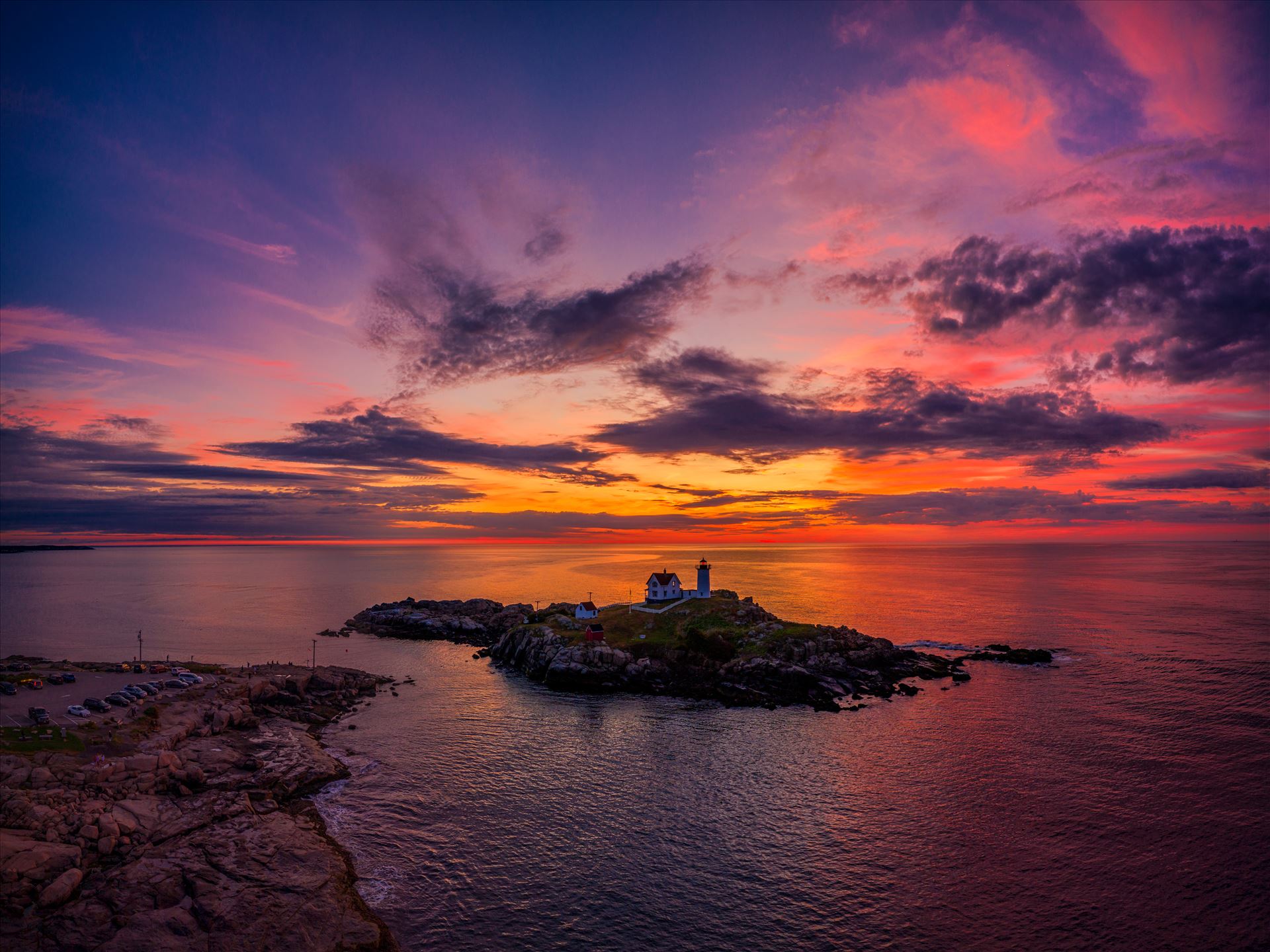 The sky is ablaze just before dawn at Cape Neddick \x22Nubble Light\x22 Lighthouse\x22 in York, Maine -  by New England Photography